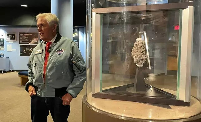 Apollo astronaut Harrison "Jack" Schmitt answers questions about his 1972 trip to the moon while standing near a moon rock on display at the New Mexico Museum of Natural History and Science in Albuquerque, N.M., on April 22, 2026. (AP Photo/Susan Montoya Bryan)