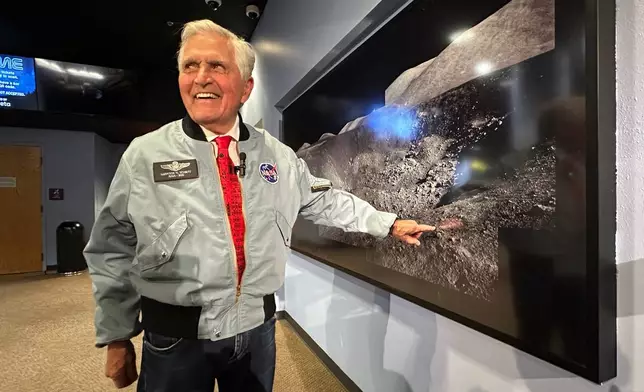 Apollo astronaut Harrison "Jack" Schmitt points to a crater where he collected samples during his 1972 moon mission, while being interviewed at the New Mexico Museum of Natural History and Science in Albuquerque, N.M., on April 22, 2026. (AP Photo/Susan Montoya Bryan)
