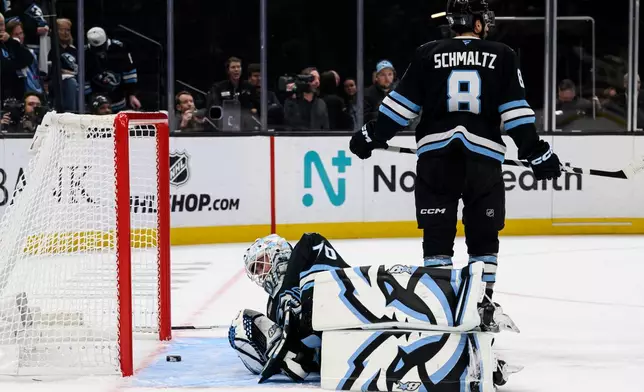 Utah Mammoth goaltender Karel Vejmelka, bottom, lays on the ice looking at the puck after giving up the winning goal during the overtime period of Game 4 of a first-round NHL hockey Stanley Cup playoff series against the Vegas Golden Knights, Monday, April 27, 2026, in Salt Lake City. (AP Photo/Tyler Tate)