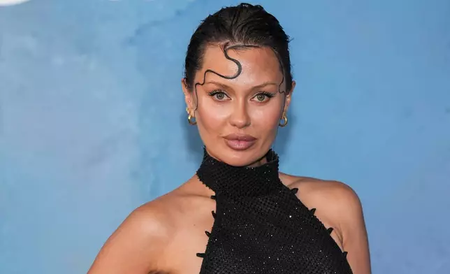 FILE - Victoria Bonya poses for photographers upon arrival at the amfAR gala at the Arsenale di Venezia, in Venice, Italy, on Sunday, Aug. 31, 2025. (Photo by Scott A Garfitt/Invision/AP, File)