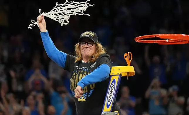 UCLA head coach Cori Close celebrates with the net after UCLA defeated South Carolina in the women's National Championship Final Four NCAA college basketball tournament game, Sunday, April 5, 2026, in Phoenix. (AP Photo/Rick Scuteri)