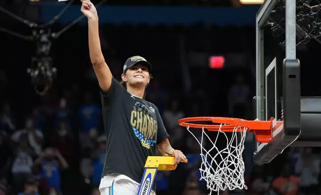 UCLA center Lauren Betts (51) celebrates after cutting down a piece of the net after UCLA defeated South Carolina in the women's National Championship Final Four NCAA college basketball tournament game, Sunday, April 5, 2026, in Phoenix. (AP Photo/Rick Scuteri)