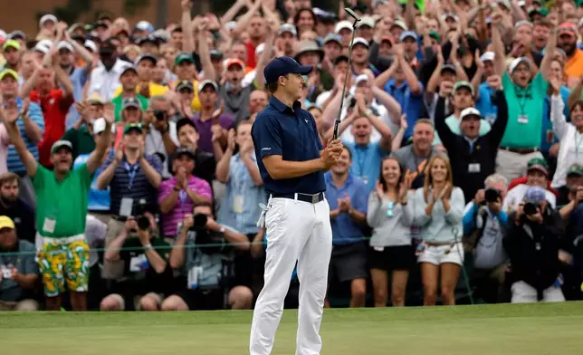 FILE - Jordan Spieth celebrates after winning the Masters golf tournament on April 12, 2015, in Augusta, Ga. (AP Photo/Matt Slocum, File)