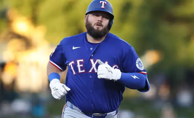 Texas Rangers' Jake Burger jogs around the bases after hitting a solo home run during the third inning of a baseball game against the Athletics, Monday, April 13, 2026, in West Sacramento, Calif. (AP Photo/Scott Marshall)