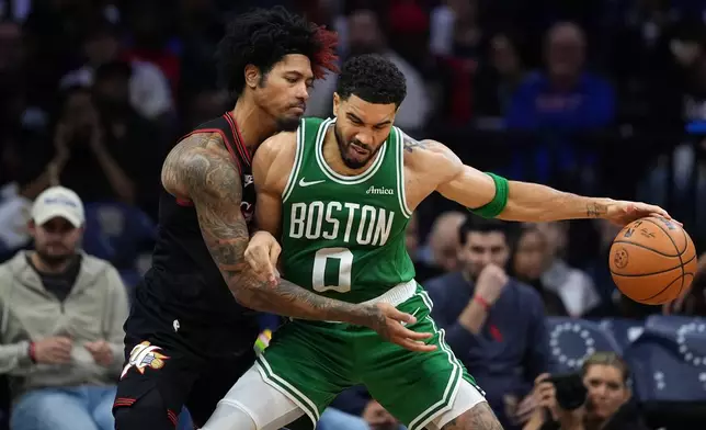 Boston Celtics' Jayson Tatum, right, tries to get past Philadelphia 76ers' Kelly Oubre Jr. during the second half of Game 4 in a first-round NBA basketball playoffs series Sunday, April 26, 2026, in Philadelphia. (AP Photo/Matt Slocum)