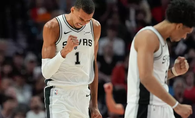 San Antonio Spurs forward/center Victor Wembanyama (1) and guard Dylan Harper, right, react after a play during the second half in Game 4 of a first-round NBA basketball playoffs series against the Portland Trail Blazers, in Portland, Ore., Sunday, April 26, 2026. (AP Photo/Jenny Kane)