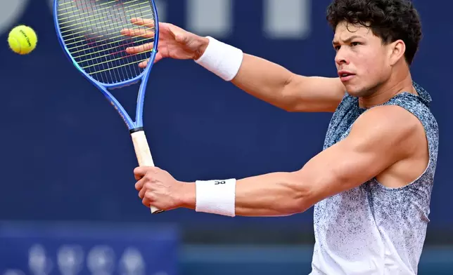 Ben Shelton of the US in action against Italy's Flavio Cobolli during the men's singles final match at the ATP Tour in Munich, Germany, Sunday April 19, 2026. (Sven Hoppe/dpa via AP)