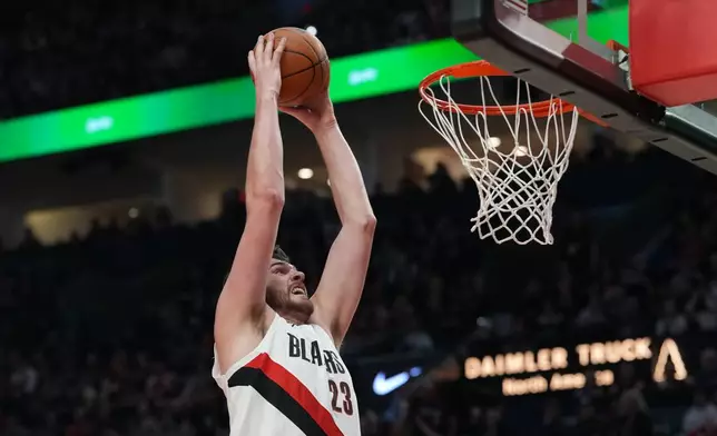Portland Trail Blazers center Donovan Clingan dunks during the first half of an NBA basketball game against the Los Angeles Clippers, Friday, April 10, 2026, in Portland, Ore. (AP Photo/Jenny Kane)