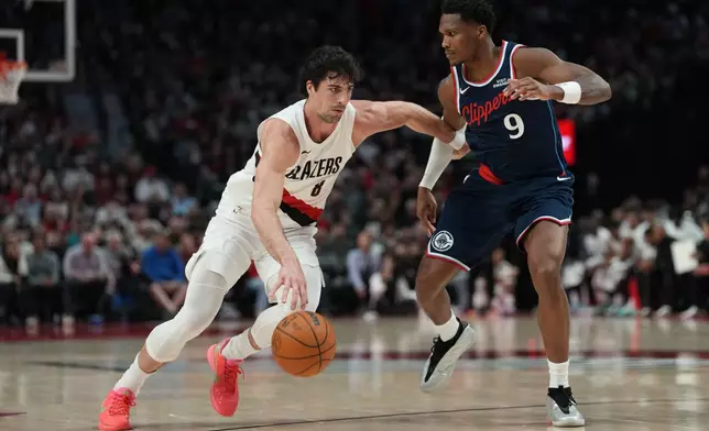 Portland Trail Blazers forward Deni Avdija (8) tries to get past Los Angeles Clippers guard/forward Bennedict Mathurin (9) during the first half of an NBA basketball game Friday, April 10, 2026, in Portland, Ore. (AP Photo/Jenny Kane)