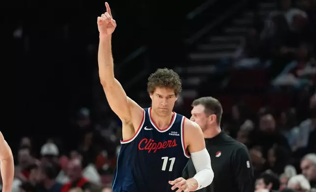 Los Angeles Clippers center Brook Lopez reacts after making a shot during the first half of an NBA basketball game against the Portland Trail Blazers, Friday, April 10, 2026, in Portland, Ore. (AP Photo/Jenny Kane)