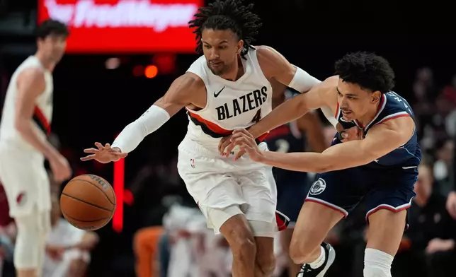 Portland Trail Blazers guard/forward Matisse Thybulle (4) looks to get past Los Angeles Clippers guard Kobe Sanders, right, during the first half of an NBA basketball game Friday, April 10, 2026, in Portland, Ore. (AP Photo/Jenny Kane)