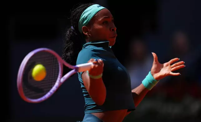 Coco Gauff of the U.S. returns the ball to Sorana Cirstea of Romania during the Madrid Open tennis tournament in Madrid, Sunday, April 26, 2026. (AP Photo/Manu Fernandez)
