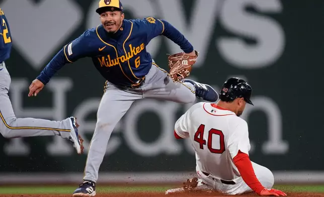 Boston Red Sox's Willson Contreras (40) is forced out by Milwaukee Brewers shortstop David Hamilton (6) during the third inning of a baseball game at Fenway Park, Monday, April 6, 2026, in Boston. (AP Photo/Charles Krupa)