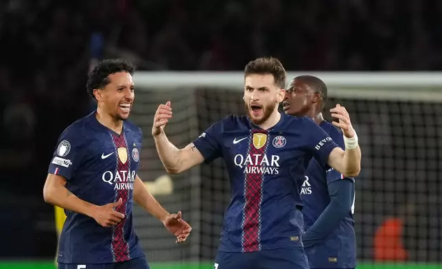 PSG's Khvicha Kvaratskhelia, center, scelebrates after scoring his side's first goal during a Champions League semifinal, first leg, soccer match between Paris Saint-Germain and Bayern Munich in Paris, Tuesday, April 28, 2026. (AP Photo/Aurelien Morissard)