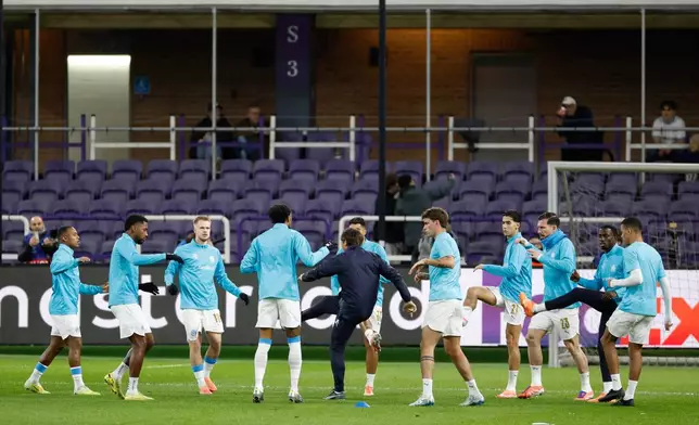 FILE - Marseille players warm up prior to the Champions League opening phase soccer match between Union SG and Marseilles in Brussels, Dec. 9, 2025. (AP Photo/Geert Vanden Wijngaert, File)