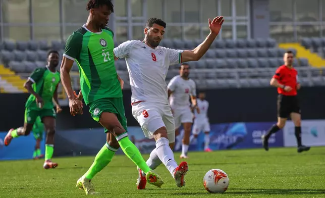 Iran's Mehdi Taremi, right, vies for the ball with Nigeria's Chibuike Nwaiwu during a friendly soccer match between Iran and Nigeria in Antalya, southern Turkey, Friday, March 27, 2026. (AP Photo/Riza Ozel)