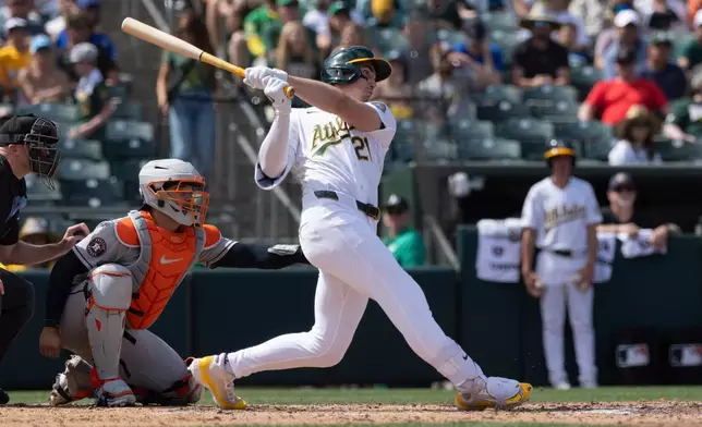 Athletics' Tyler Soderstrom (21) hits a three-run triple during the fifth inning of a baseball game against the Houston Astros, Sunday, April 5, 2026, in West Sacramento, Calif. (AP Photo/Sara Nevis)