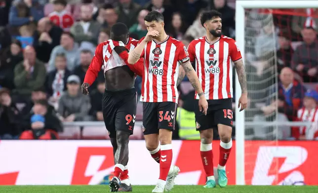 Sunderland's Granit Xhaka (34), Brian Brobbey (9) and Omar Alderete appear dejected after Nottingham Forest scored a fourth goal during the Premier League soccer match between Sunderland and Nottingham Forest, Friday, April 24, 2026, in Sunderland, England. (Richard Sellers/PA via AP)