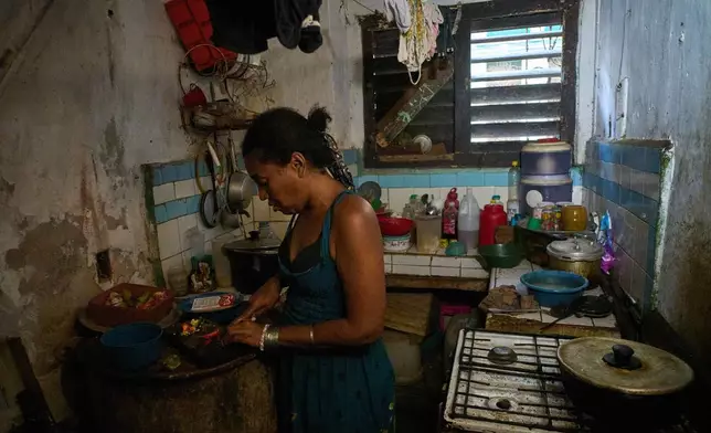 Yuneisy Riviaux prepares dinner in her kitchen in Havana, Cuba, Wednesday, March 25, 2026. (AP Photo/Ramon Espinosa)