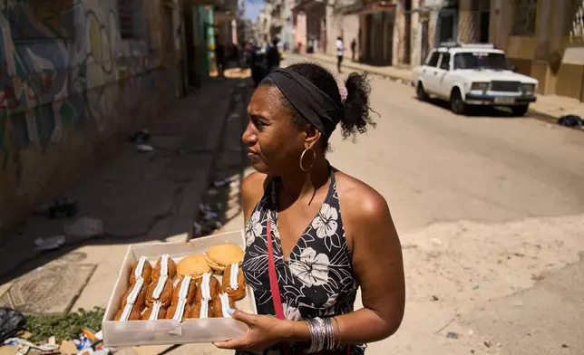 Yuneisy Riviaux sells pastries in Havana, Cuba, Saturday, March 28, 2026. (AP Photo/Ramon Espinosa)