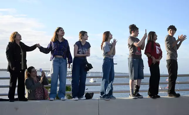 Spectators view NASA's Artemis II moon rocket launch from the A. Max Brewer Bridge, Wednesday, April 1, 2026, in Titusville, Fla. (AP Photo/Phelan M. Ebenhack)