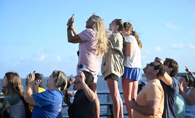 Spectators view NASA's Artemis II moon rocket launch from the A. Max Brewer Bridge, Wednesday, April 1, 2026, in Titusville, Fla. (AP Photo/Phelan M. Ebenhack)