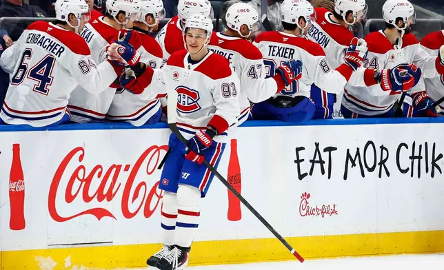 Montréal Canadiens right wing Ivan Demidov (93) is congratulated by teammates after scoring a goal against the New York Islanders during the second period of an NHL hockey game, Sunday, April 12, 2026, in Elmont, N.Y. (AP Photo/Noah K. Murray