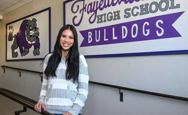 Fayetteville High senior Lily Adler, president of the Young Democrats of Arkansas, is photographed in the halls at Fayetteville High School Tuesday, April, 7, 2026 in Fayetteville, Ark. (AP Photo/Michael Woods) CORRECTION: Adler, not Alder