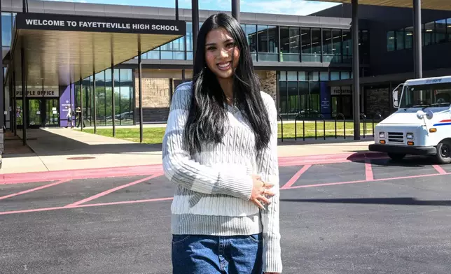Fayetteville High senior Lily Alder, president of the Young Democrats of Arkansas, in front of Fayetteville High School Tuesday, April, 7, 2026 in Fayetteville, Ark. (AP Photo/Michael Woods)