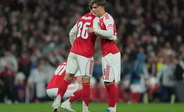 Arsenal's Martin Zubimendi, left, and Max Dowman hug afterthe UEFA Champions League second leg quarterfinal soccer match between Arsenal and Sporting in London, England, Wednesday, April 15, 2026. (AP Photo/Kin Cheung)