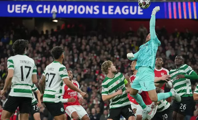 Sporting's goalkeeper Rui Silva punches the ball during the UEFA Champions League second leg quarterfinal soccer match between Arsenal and Sporting in London, England, Wednesday, April 15, 2026. (AP Photo/Kin Cheung)