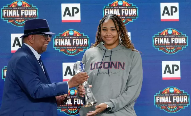 Associated Press deputy global sports editor Oscar Dixon, left, presents UConn's Sarah Strong with the 2026 AP Women's Player of the Year award during a news conference at the Women's Final Four of the NCAA college basketball tournament, Thursday, April 2, 2026, in Phoenix. (AP Photo/Ross D. Franklin)