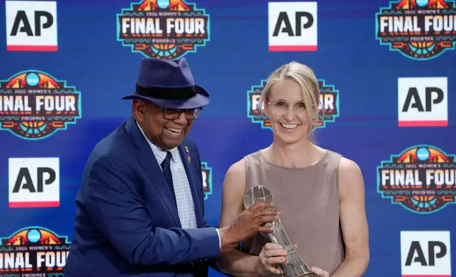 Associated Press deputy global sports editor Oscar Dixon, left, presents Vanderbilt women's basketball head coach Shea Ralph with the 2026 AP Women's Coach of the Year award during a news conference at the Women's Final Four of the NCAA college basketball tournament, Thursday, April 2, 2026, in Phoenix. (AP Photo/Ross D. Franklin)