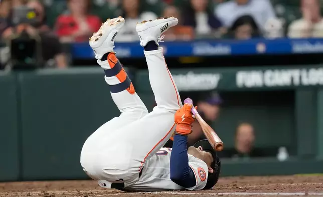 Houston Astros' Joey Loperfido falls after being hit by a pitch thrown by Colorado Rockies pitcher Chase Dollander during the fourth inning of a baseball game Thursday, April 16, 2026, in Houston. (AP Photo/David J. Phillip)