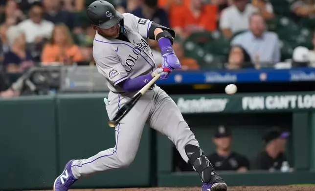 Colorado Rockies' Hunter Goodman hits a home run against the Houston Astros during the fourth inning of a baseball game Thursday, April 16, 2026, in Houston. (AP Photo/David J. Phillip)