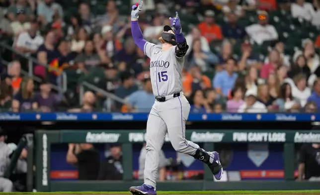 Colorado Rockies' Hunter Goodman celebrates after hitting a home run against the Houston Astros during the fourth inning of a baseball game Thursday, April 16, 2026, in Houston. (AP Photo/David J. Phillip)