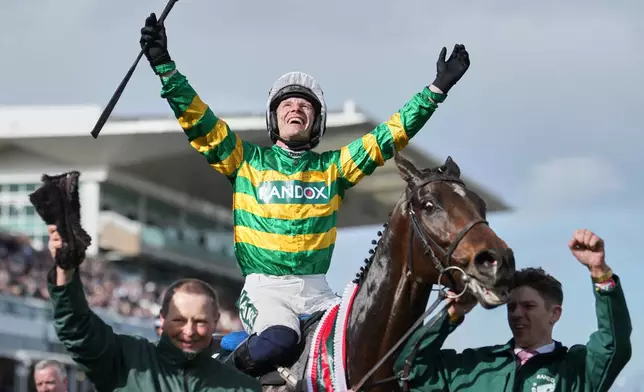 Jockey Paul Townend celebrates on I Am Maximus after winning the Grand National horse race at Aintree racecourse in Liverpool, Saturday, April 11, 2026. (AP Photo/Jon Super)