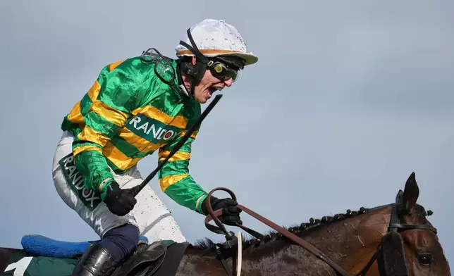 Jockey Paul Townend celebrates on I Am Maximus after winning the Grand National horse race at Aintree racecourse in Liverpool, Saturday, April 11, 2026. (AP Photo/Jon Super)