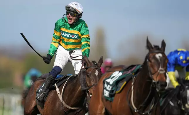 Jockey Paul Townend celebrates on I Am Maximus after winning the Grand National horse race at Aintree racecourse in Liverpool, Saturday, April 11, 2026. (AP Photo/Jon Super)