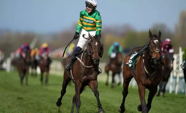 Jockey Paul Townend celebrates on I Am Maximus after winning the Grand National horse race at Aintree racecourse in Liverpool, Saturday, April 11, 2026. (AP Photo/Jon Super)