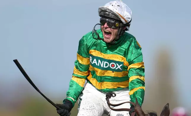 Jockey Paul Townend celebrates on I Am Maximus after winning the Grand National horse race at Aintree racecourse in Liverpool, Saturday, April 11, 2026. (AP Photo/Jon Super)