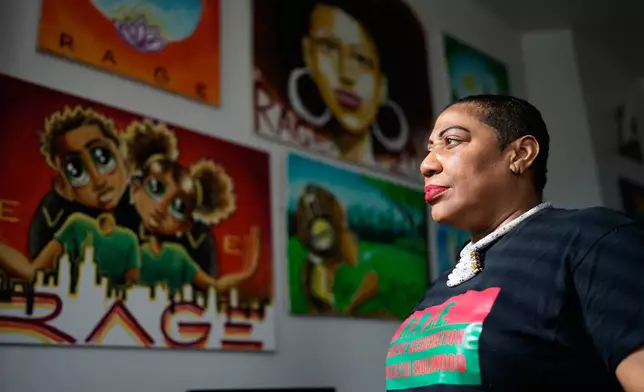 Asiaha Butler, the co-founder of the Resident Association of Greater Englewood, looks to outside from her office in Chicago, Monday, April 6, 2026. (AP Photo/Nam Y. Huh)
