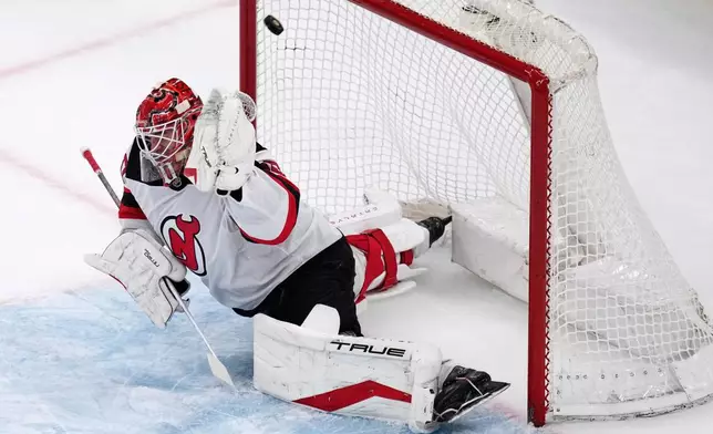New Jersey Devils goaltender Nico Daws (50) fails to make a save on a shot by Boston Bruins center Mark Kastelic during the first period of a hockey game, Tuesday, April 14, 2026, in Boston. (AP Photo/Charles Krupa)