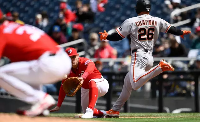San Francisco Giants' Matt Chapman (26) is safe at first with a single against Washington Nationals first baseman Curtis Mead, center, during the third inning of a baseball game, Sunday, April 19, 2026, in Washington. (AP Photo/Nick Wass)