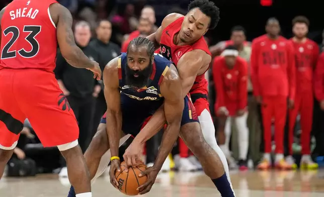 Cleveland Cavaliers guard James Harden, center, keeps the ball fron Toronto Raptors forward Scottie Barnes, right, in the second half in Game 2 of a first-round NBA basketball playoffs series in Cleveland, Monday, April 20, 2026. (AP Photo/Sue Ogrocki)