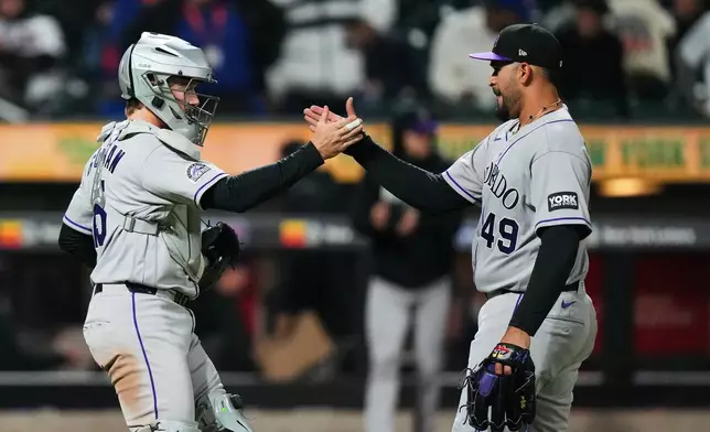 Colorado Rockies pitcher Antonio Senzatela, right, celebrates with catcher Hunter Goodman after a baseball game against the New York Mets Friday, April 24, 2026, in New York. (AP Photo/Frank Franklin II)