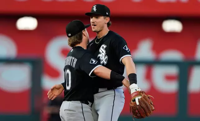 Chicago White Sox' Colson Montgomery, right, and Chase Meidroth (10) celebrate after their baseball game against the Kansas City Royals, Sunday, April 12, 2026, in Kansas City, Mo. (AP Photo/Charlie Riedel)