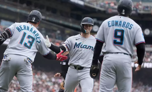 Miami Marlins' Graham Pauley, middle, is congratulated by Heriberto Hernández (13) after hitting a three-run home run that also scored Xavier Edwards (9) and Liam Hicks during the second inning of a baseball game against the San Francisco Giants Sunday, April 26, 2026, in San Francisco. (AP Photo/Jeff Chiu)