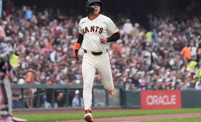 San Francisco Giants' Jung Hoo Lee runs home to score against the Miami Marlins during the third inning of a baseball game Sunday, April 26, 2026, in San Francisco. (AP Photo/Jeff Chiu)