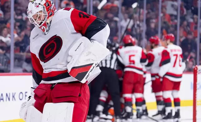 Carolina Hurricanes goalie Brandon Bussi reacts to the collision with Philadelphia Flyers right winger Owen Tippett during the second period of an NHL hockey game, Monday, April 13, 2026, in Philadelphia. (AP Photo/Chris Szagola)
